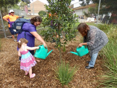 Tom's sister Kim on the right &  her niece & grandniece on the left watering the tree for the first time.  Marrickville Council even brought watering cans for the family to water the tree.